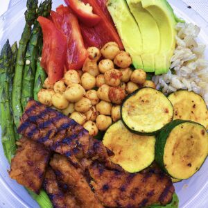 Served with brown rice, asparagus, zucchini, sweet bell peppers, and avocado