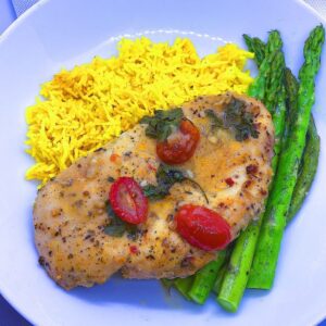 Baked Chicken Velouté served with turmeric rice and baked asparagus