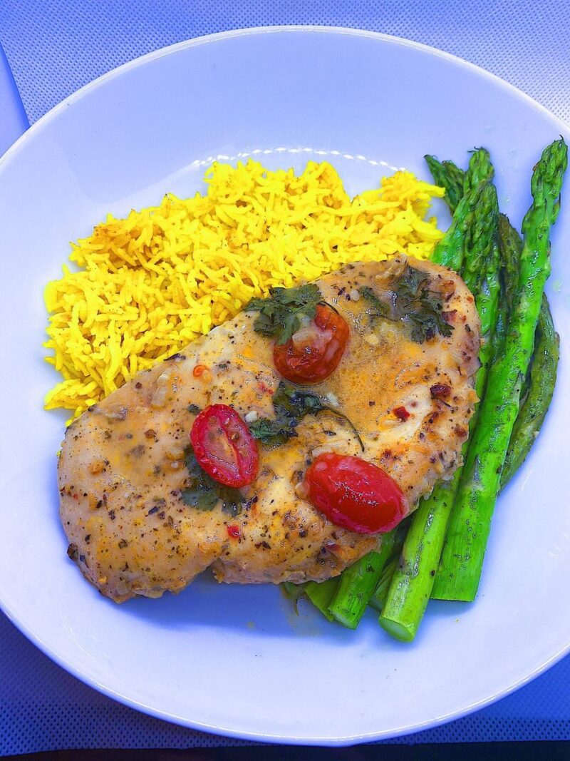 Baked Chicken Velouté served with turmeric rice and baked asparagus