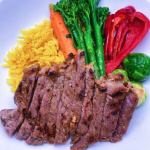 Chipotle Steak. Served with turmeric rice, broccolini, Brussels sprouts, and sweet bell peppers