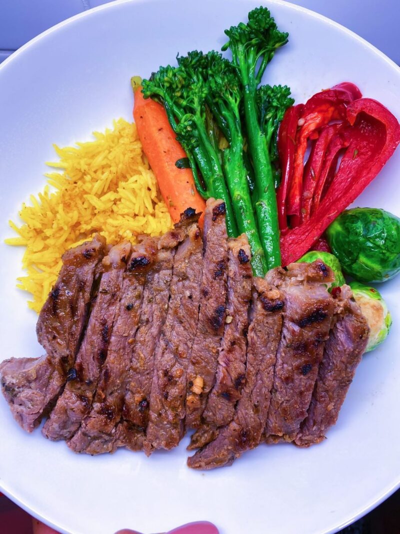 Chipotle Steak. Served with turmeric rice, broccolini, Brussels sprouts, and sweet bell peppers