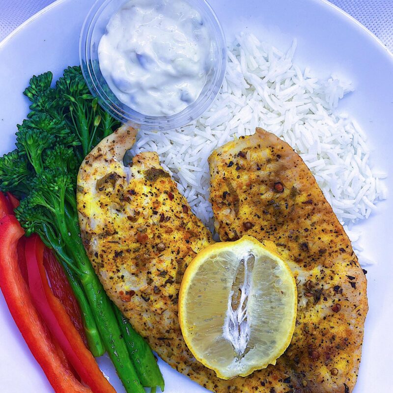 Lemon Pepper Tilapia Served with a side of basmati rice, broccoli, bell peppers, and a side of tartar sauce