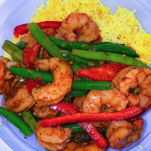 Served with turmeric rice, green beans, and sweet bell peppers