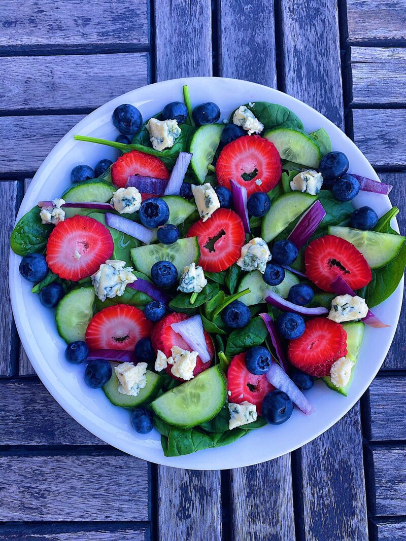 Blueberries, strawberries, cucumbers, red onions, and crumbled blue cheese