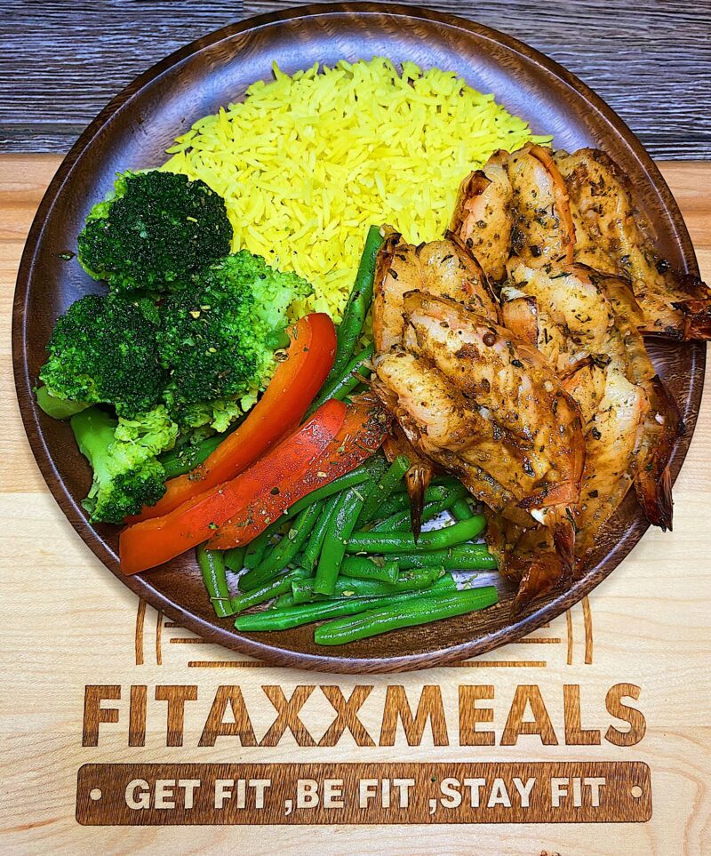 Colossal baked butterfly cajun shrimp with turmeric rice and mixed vegetables