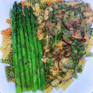 Baked chicken breast, mushrooms, and creamy stroganoff sauce served with pasta and a side of baked asparagus