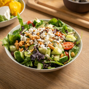 Made with spring mix, tomatoes, cucumbers, red bell peppers, raisins, dried cranberries, sunflower seeds and feta cheese. Served with a side of honey citrus dressing