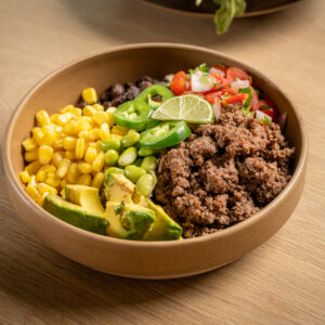 Ground beef served with basmati rice, edamame, black beans, corn, tomatoes, and a side of guacamole.