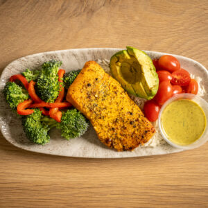 Salmon bowl made with basmati rice, mixed vegetables, and grape tomatoes. Served with home-made green sauce