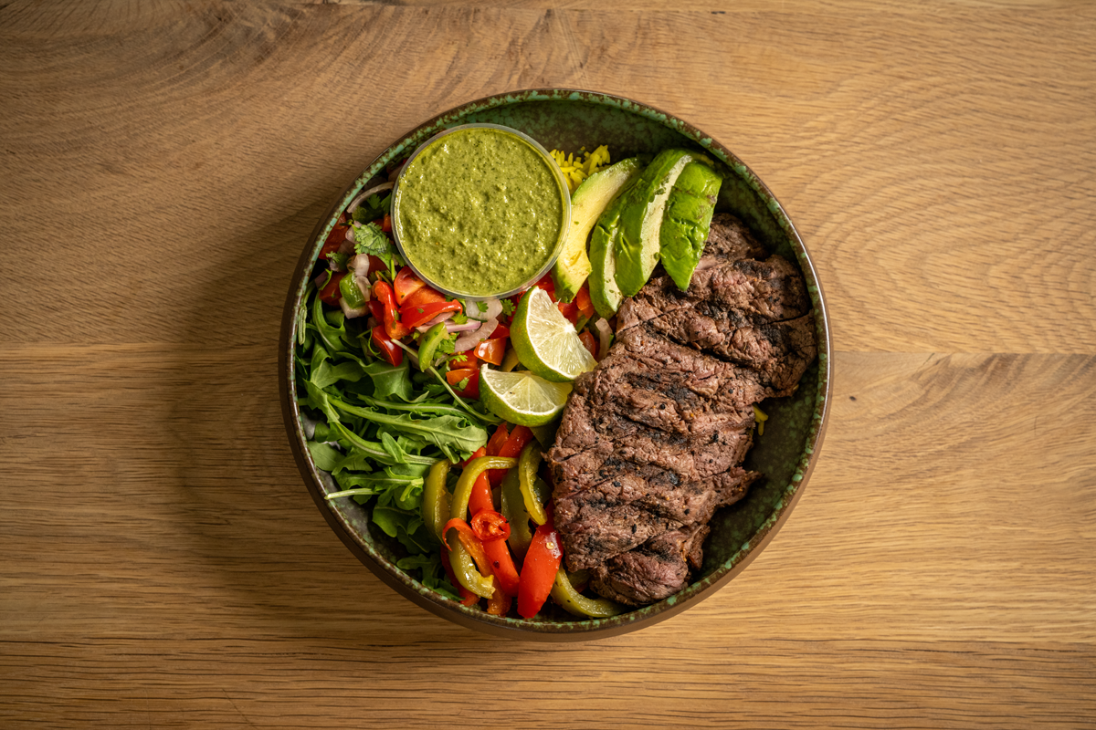 Grilled steak served with turmeric rice, arugula, mixed bell peppers and onions, our pico de gallo salsa, and our house-made chimichurri sauce.