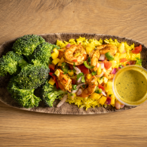 Grilled cajun shrimp with our house mango salsa, served with turmeric rice, and broccoli