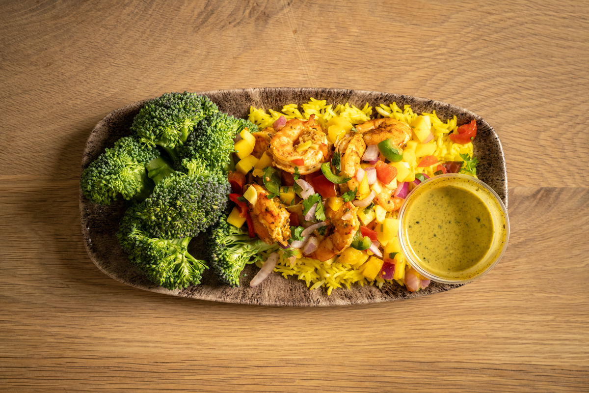 Grilled cajun shrimp with our house mango salsa, served with turmeric rice, and broccoli