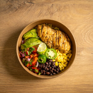 Mexican Chicken Bowl served with turmeric rice, cherry tomatoes, beans, corn, and a side of guacamole